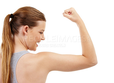 Buy stock photo A teenage girl checking out her bicep muscles after a workout