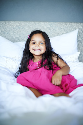 Buy stock photo Shot of an adorbale little girl posing comfortably on the bed