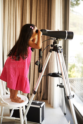 Buy stock photo Girl, child and telescope by window in home with view of sky with vision, learning and thinking. Kid, glass and playing with equipment for zoom perspective of space, stars or universe at family house