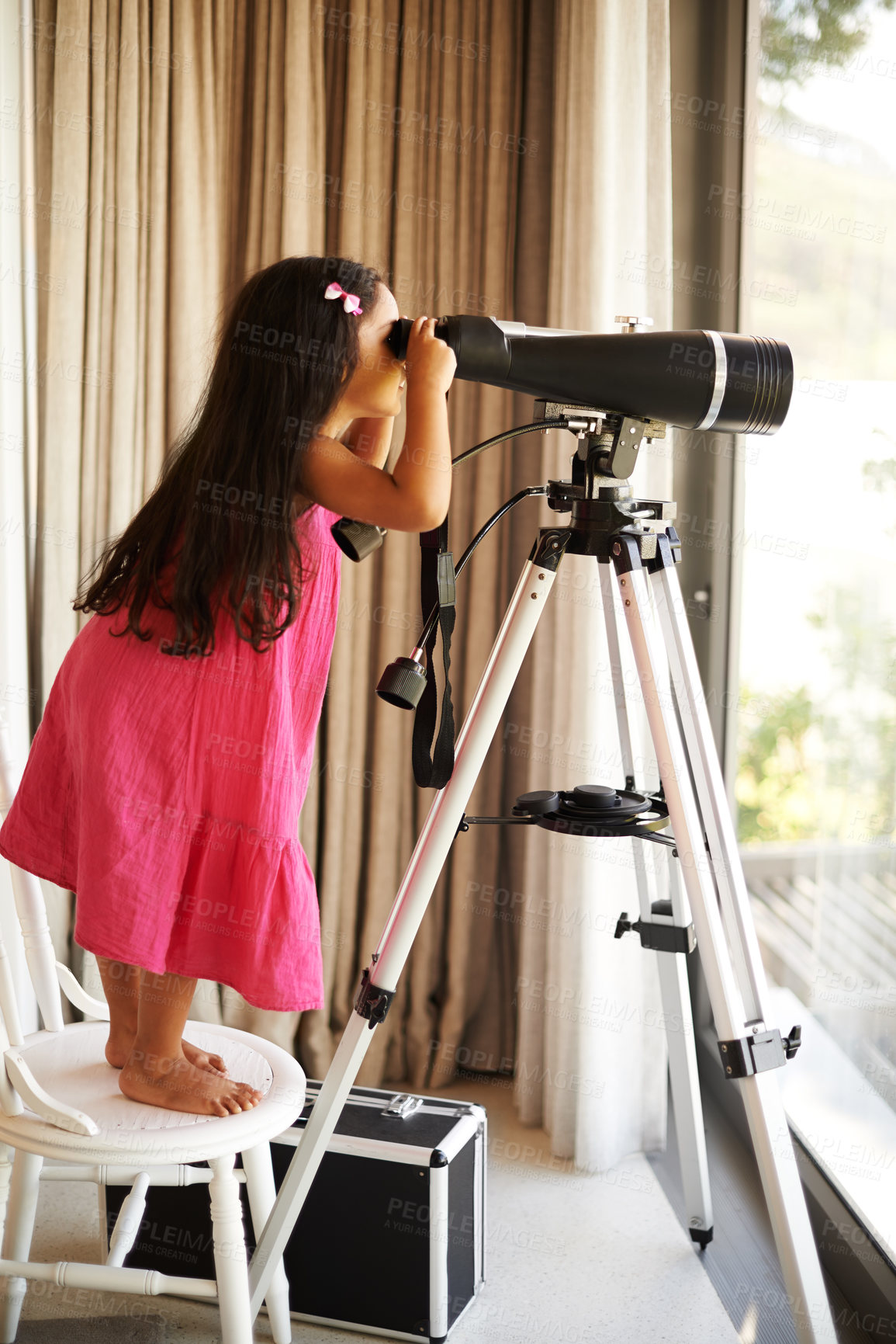 Buy stock photo Girl, child and telescope by window in home with view of sky with vision, learning and thinking. Kid, glass and playing with equipment for zoom perspective of space, stars or universe at family house