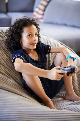 Buy stock photo Shot of a cute little boy enjoying his video games