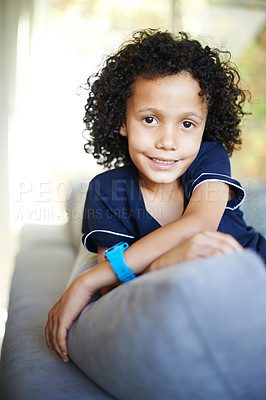 Buy stock photo Boy child, smile and sofa with portrait on weekend break for relax in living room for growth and development with resting. Young, man and couch in apartment for leisure with happiness in afternoon.