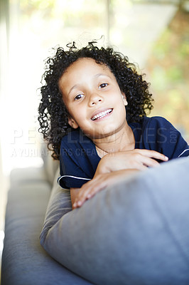 Buy stock photo Portrait, smile and child on sofa for relaxation, play and happy for weekend in living room. Young boy, couch and holiday from school for vacation, break and lounge in family home for security