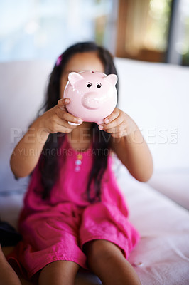 Buy stock photo Girl, child and piggy bank on sofa in home for saving, investment and learning to plan with money. Kid, animal container and box for cash, education and future for financial freedom in family house