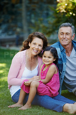 Buy stock photo Smile, nature and child with grandparents in park bonding together on outdoor family vacation. Happy, love and girl kid with senior man and woman relaxing on grass in garden for countryside holiday.