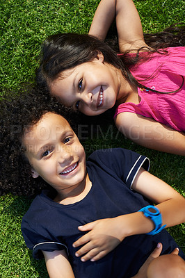 Buy stock photo Cropped shot of a smiling brother and sister lying on the grass
