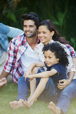 Buy stock photo Smile, nature and child with parents in park bonding together on outdoor family vacation. Happy, love and boy kid with mother and father relaxing on grass in garden for countryside holiday or trip.