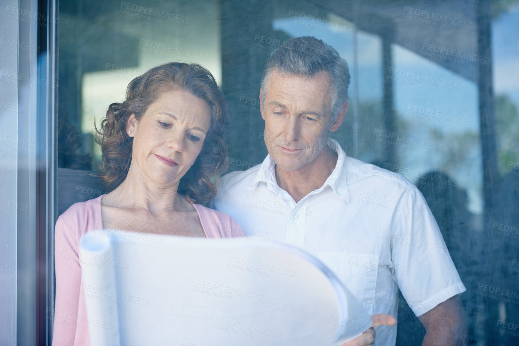 Buy stock photo Architecture, renovation and senior couple in house for building with retirement, design idea and future home. Window, elderly man and woman with blueprint for remodeling, construction and floor plan