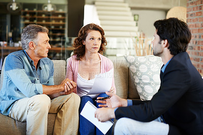 Buy stock photo Mature couple, worried and lawyer with documents for mortgage for debt for planning, finances and advice. Man, woman and consultant for pension, offer or agreement in lounge with advisor in home
