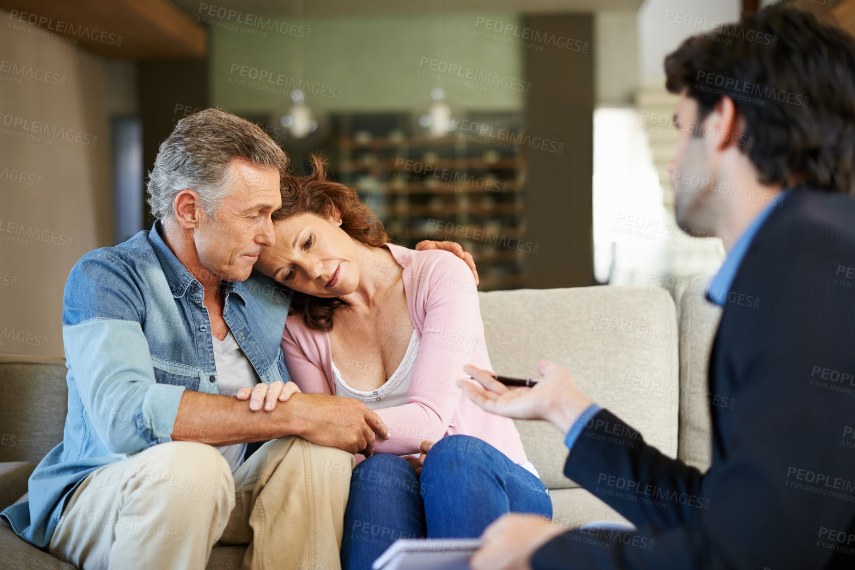 Buy stock photo Mature couple, therapist and support in house for relationship for depression in health, stress and advice. Man, woman and psychologist for talking, hug or embrace in lounge with counsellor in home