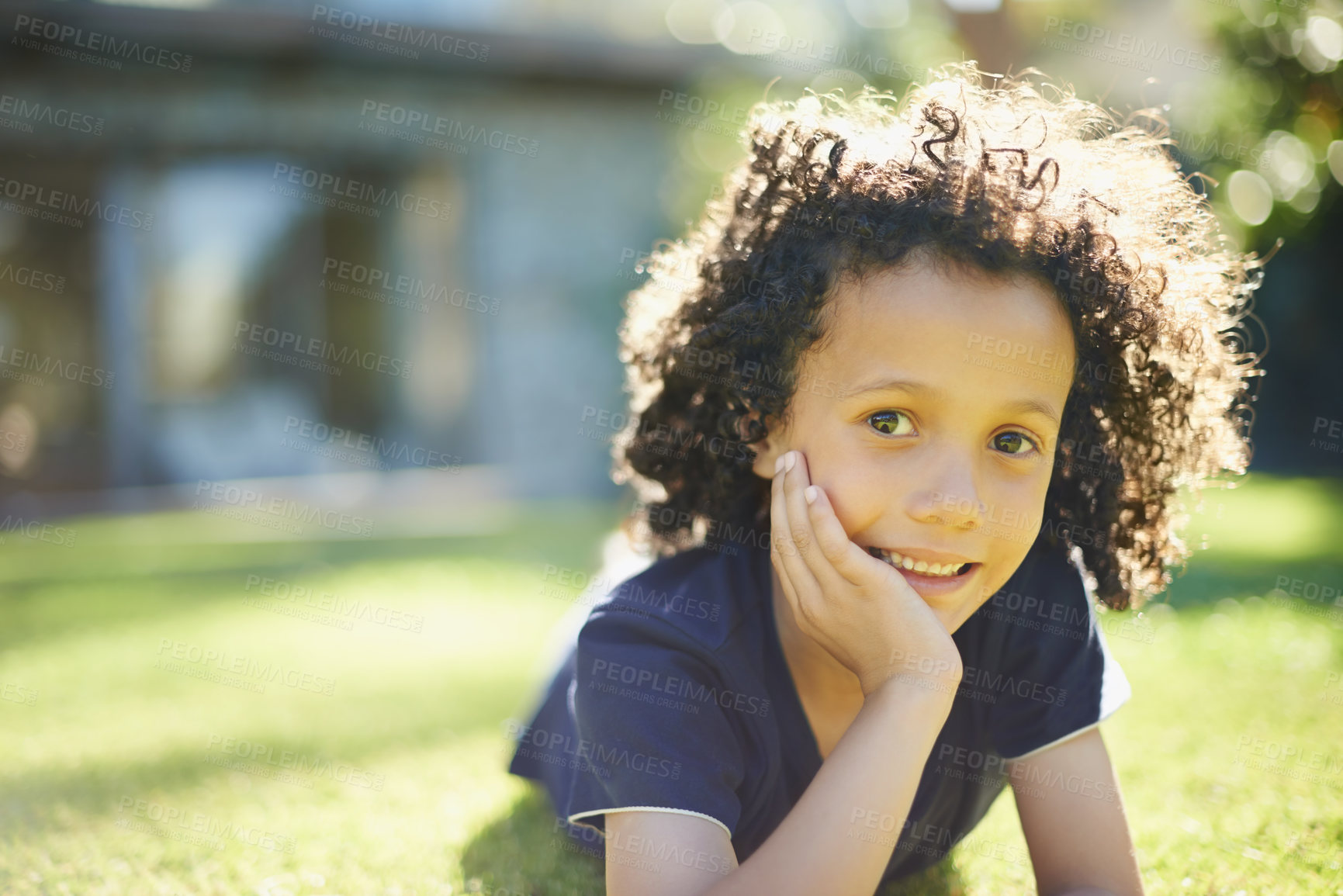 Buy stock photo Smile, nature and portrait of child in backyard relaxing on grass for development or fun in sunshine. Happy, sweet and cute boy kid laying on lawn in outdoor garden with positive attitude at home.