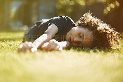 Buy stock photo A cute little boy napping on the grass in the garden