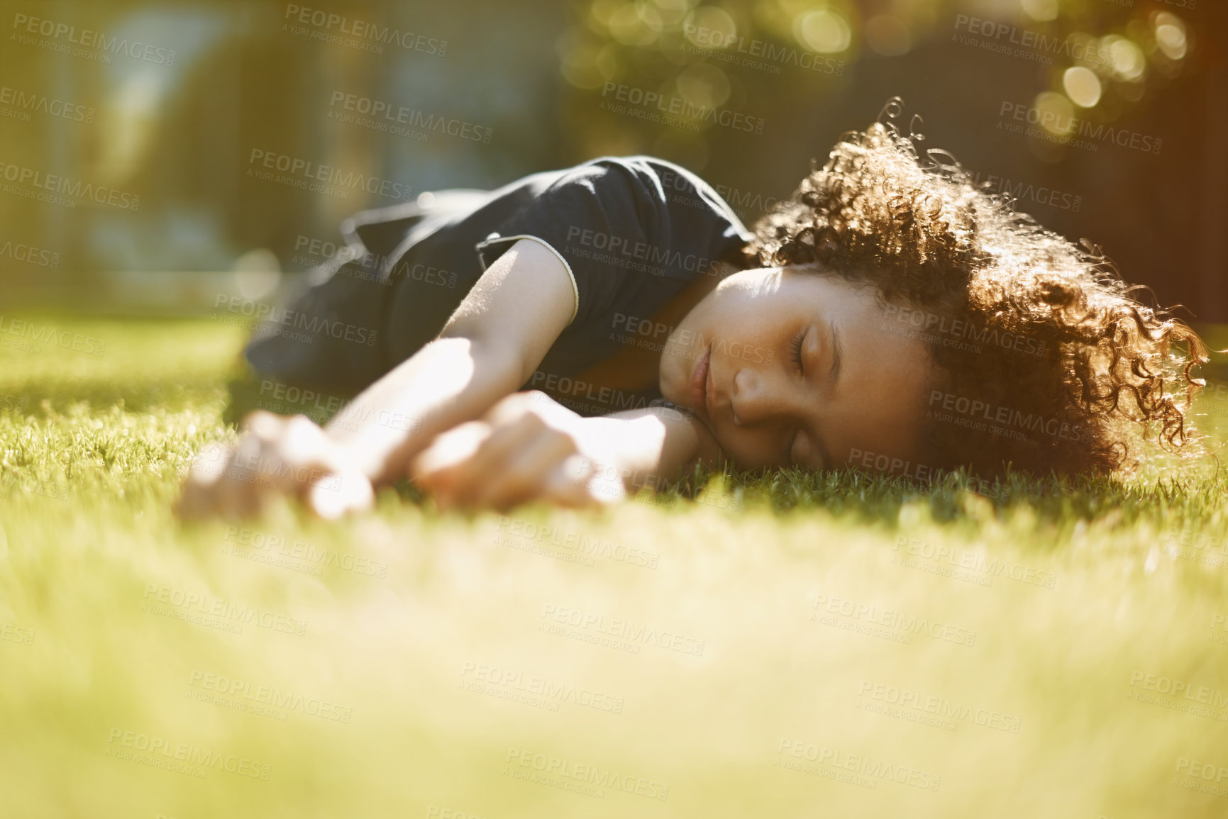 Buy stock photo Boy, child and sleeping on grass in garden of home for resting, exhausted and tired with dreaming in nature. Kid, fatigue and nap on lawn in backyard with comfort, peace or relax for wellness outdoor