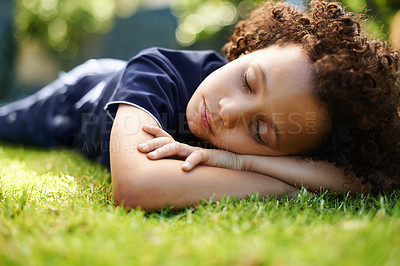 Buy stock photo Boy, child and sleeping on lawn in garden of home for resting, exhausted and tired with dreaming in nature. Kid, fatigue and nap on grass in backyard with comfort, peace or relax for wellness outdoor