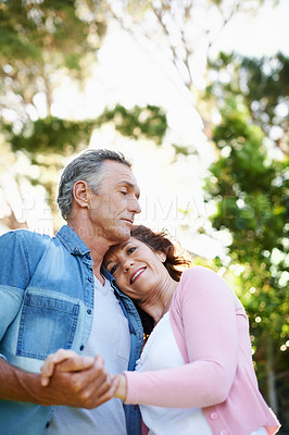 Buy stock photo A loving mature couple spending time outdoors together