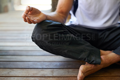 Buy stock photo Cropped view of a man doing yoga in the lotus position