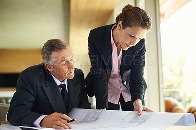 Buy stock photo Businessman, architect and plans with office, discussion and collaboration for engineering project. Mature woman, man and architecture with teamwork, blueprints and review for construction design