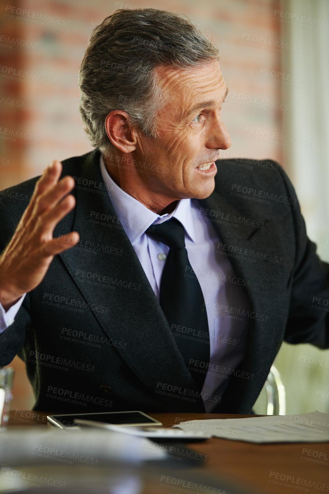 Buy stock photo Mature ceo, digital tablet and discussion at table for meeting, battle plan and strategy in corporate workplace. Businessman, talking and conference in office for finances, planning and leadership