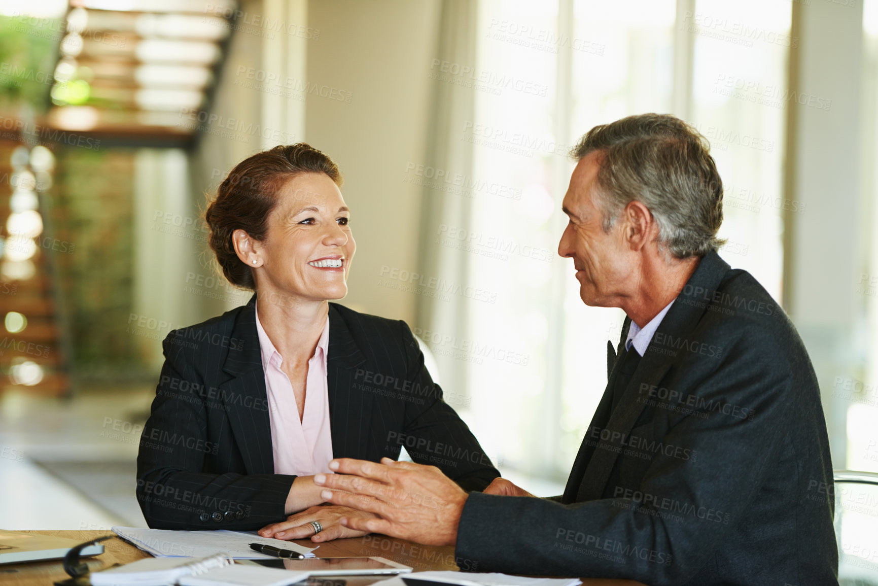 Buy stock photo Conversation, office and mature business people for meeting with teamwork, notes and planning project strategy. Financial advisor job, man and woman by desk with feedback discussion and cooperation