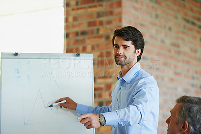 Buy stock photo A professional young businessman doing a presentation 