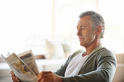 Buy stock photo Mature, man and newspaper for reading in home, relax and information or articles in morning with coffee. News, breakfast table and rest and calm for entertainment pages, current events in apartment