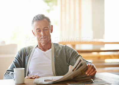 Buy stock photo Mature, man and newspaper for reading in home, relax and information or articles in morning with coffee. News, breakfast table and rest and calm for entertainment pages, current events in apartment
