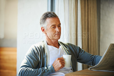 Buy stock photo Mature, man and newspaper for reading in home, relax and information or articles in morning with coffee. News, breakfast table and rest and calm for entertainment pages, current events in apartment