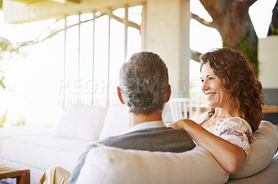 Buy stock photo Relax, happy or mature couple in home living room for conversation or communication in marriage. Smile, bonding or woman on sofa speaking to man in retirement, house or discussion on couch together