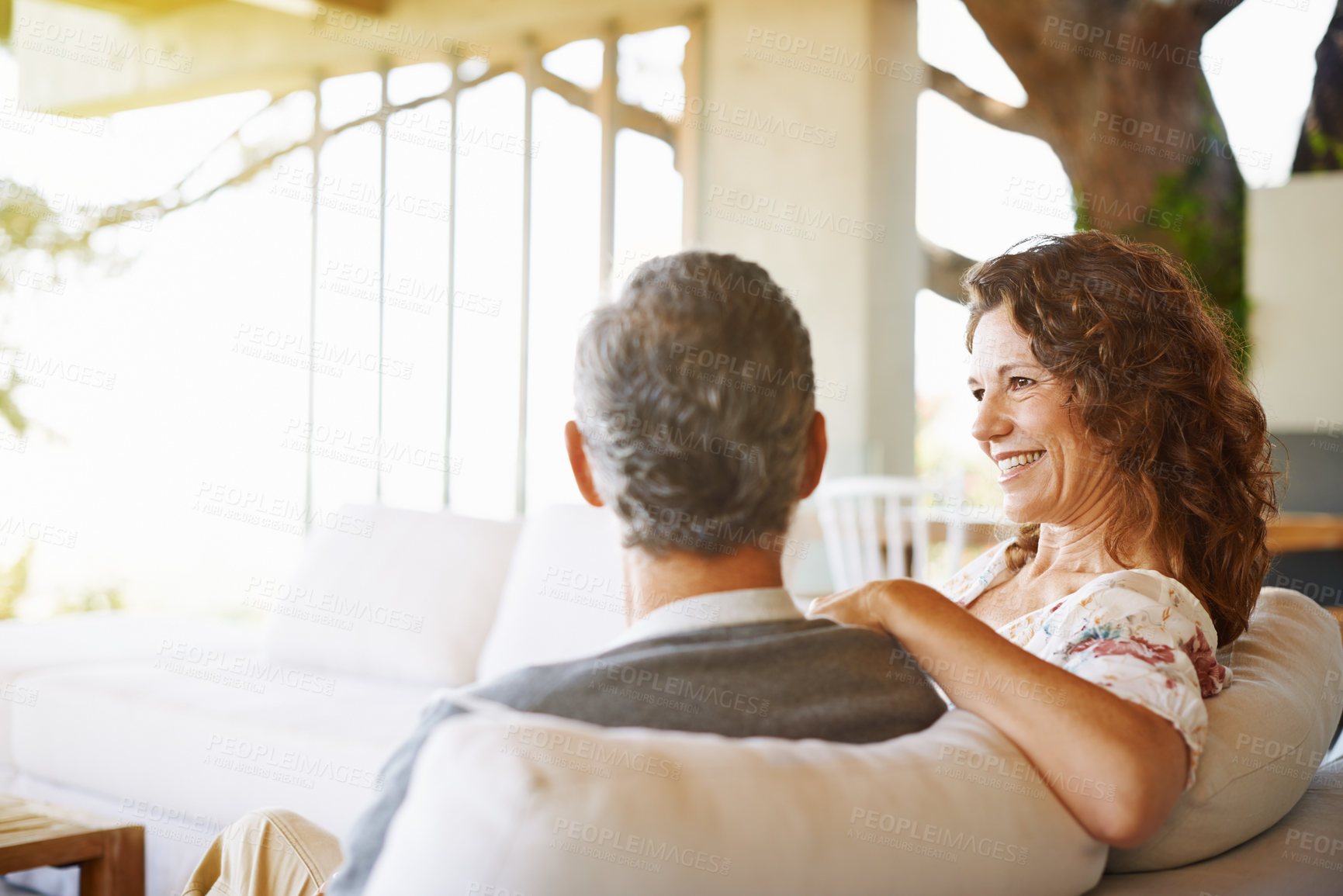 Buy stock photo Relax, happy or mature couple in home living room for conversation or communication in marriage. Smile, bonding or woman on sofa speaking to man in retirement, house or discussion on couch together