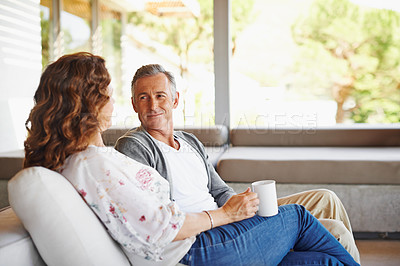 Buy stock photo Listen, coffee or mature couple in home living room for conversation or communication in marriage. Peace, drinking tea or woman speaking to man in retirement, house or discussion to relax together