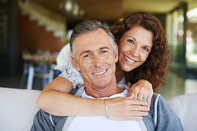 Buy stock photo A handsome mature man being lovingly embraced by his smiling wife