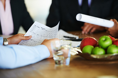 Buy stock photo Cropped view of businesspeople holding paperwork during a meeting