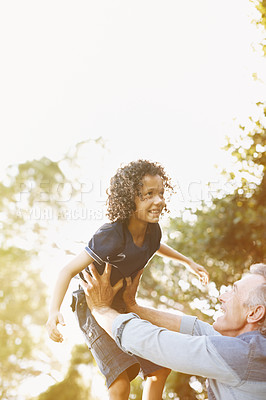 Buy stock photo A grandfather playing with his grandson in the park