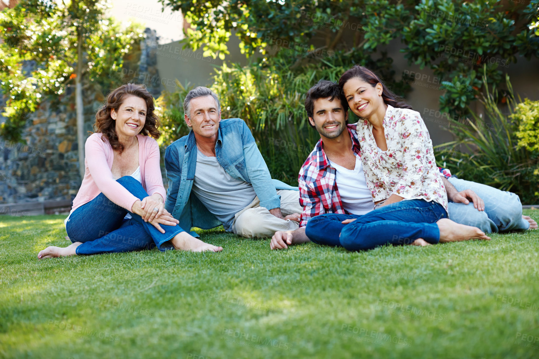 Buy stock photo Couple, happy and parents on lawn for family, reunion or celebration in backyard for picnic on grass. Mature, people and outdoors as inlaws in bonding, together and love as relatives or community