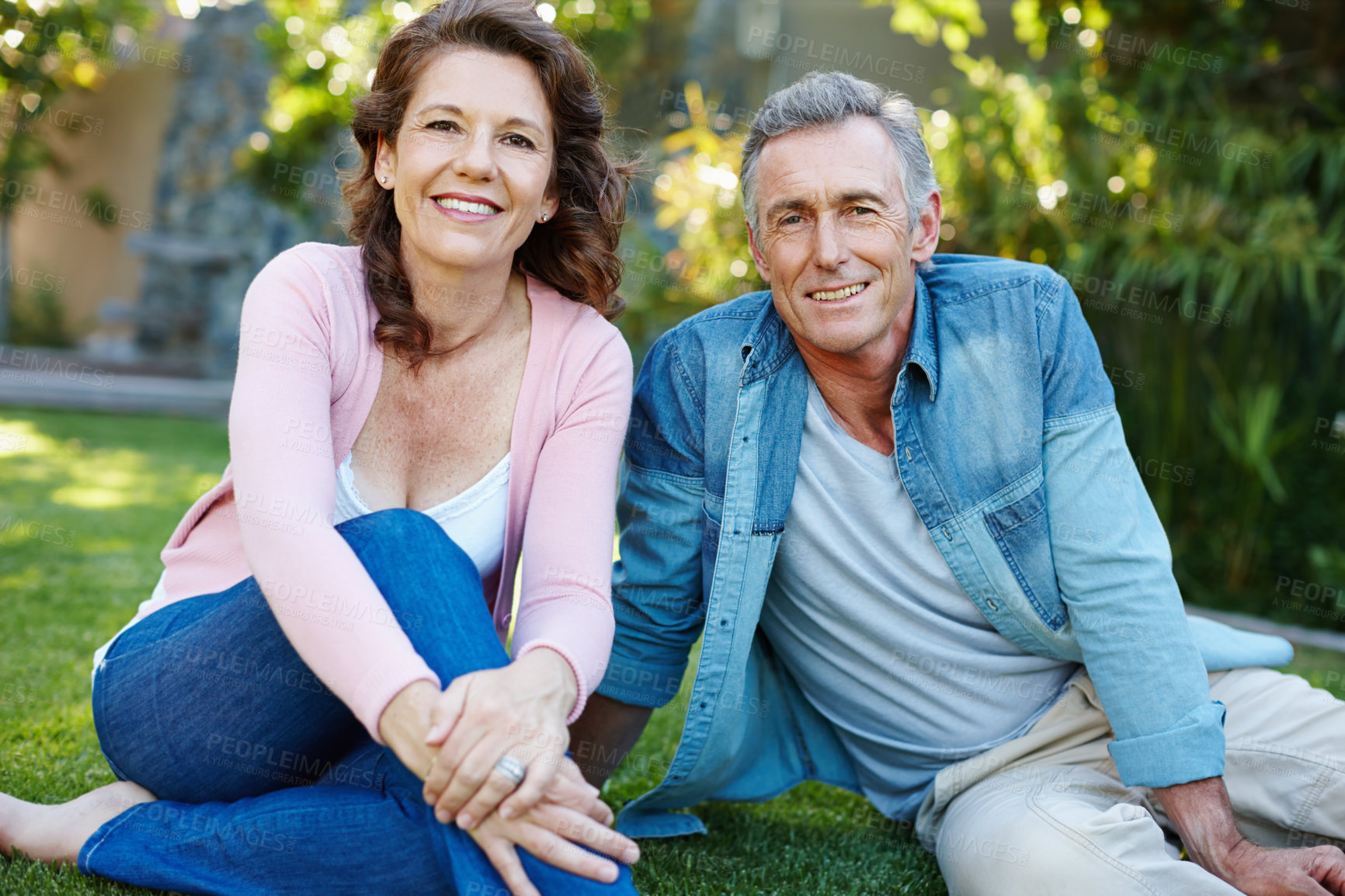 Buy stock photo Outdoor, bonding and relax for mature couple, grass and happy in backyard, love and romance for people in home. Nature, man and woman on ground in park, smile and peace for marriage and honeymoon
