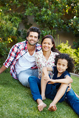 Buy stock photo Smile, nature and portrait of kid with parents in park bonding together on outdoor family vacation. Happy, love and boy child with mother and father relax on grass in garden for countryside holiday.