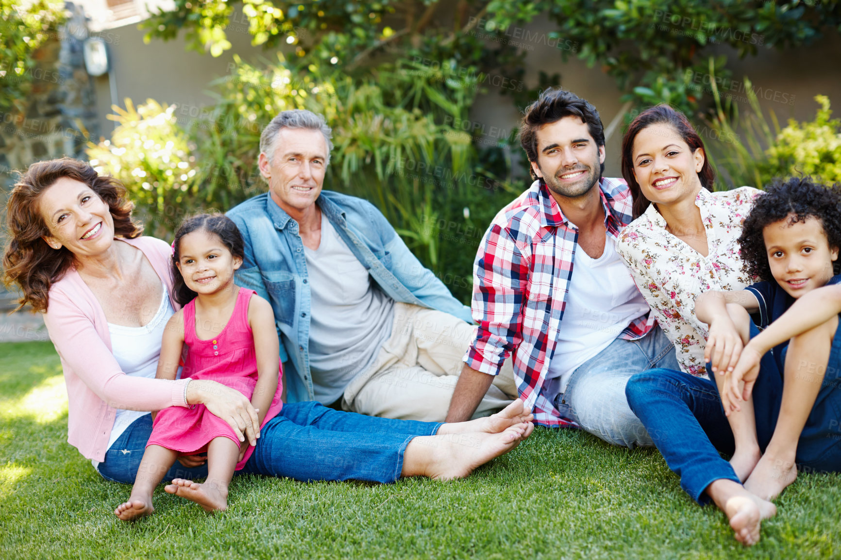 Buy stock photo Three generations of a happy family spending time together in the park