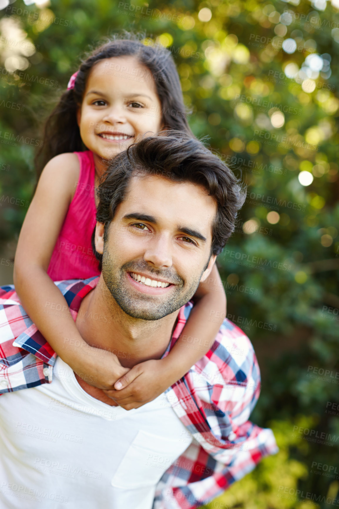 Buy stock photo A handsome young father piggybacking his cute young daughter