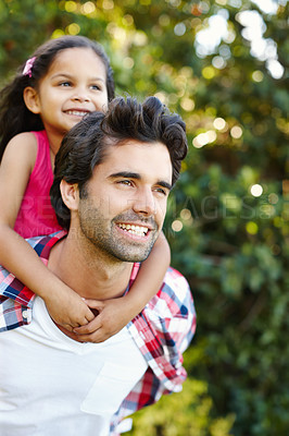 Buy stock photo A handsome young father piggybacking his cute young daughter