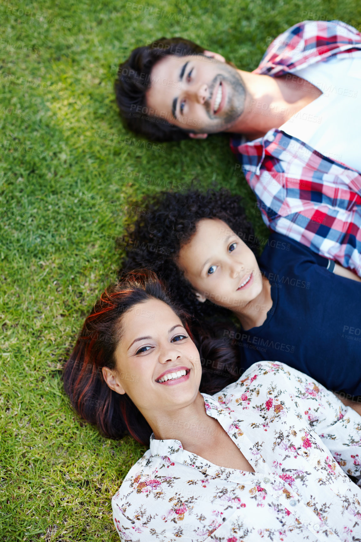 Buy stock photo Top view, relax and family on grass, portrait and happiness with smile, bonding together and cheerful. Face, joyful parents or boy with love, outdoor and son with mother, father or nature with summer