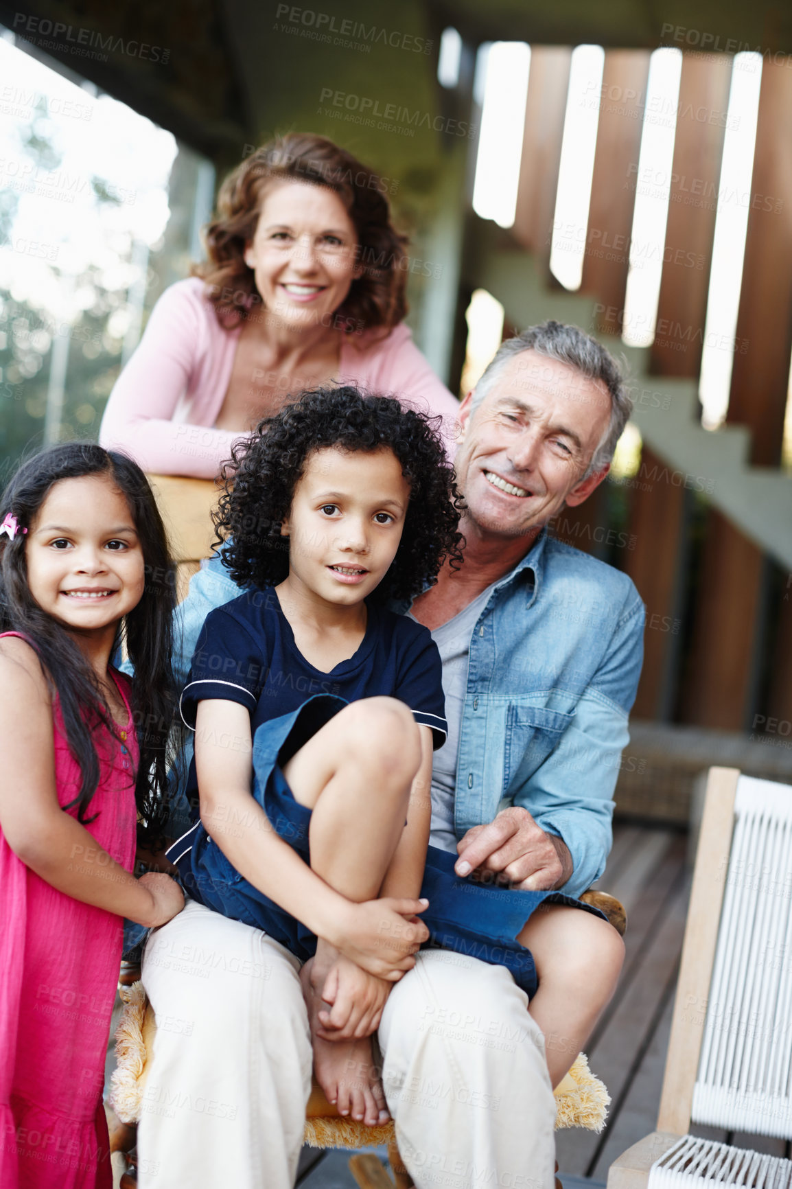 Buy stock photo Two smiling grandparents posing with their grandchildren 
