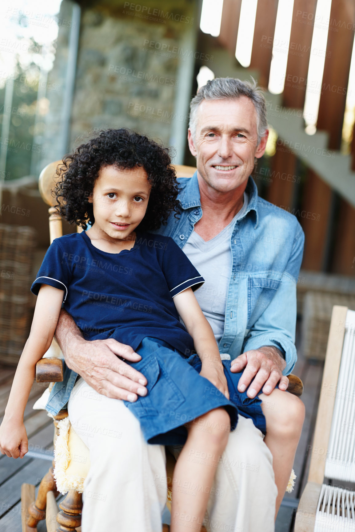 Buy stock photo Grandfather, boy and smile in patio in home with bonding, support and care for child development. People, kid and smile in chair for memories, fun and growth as family together for love and trust