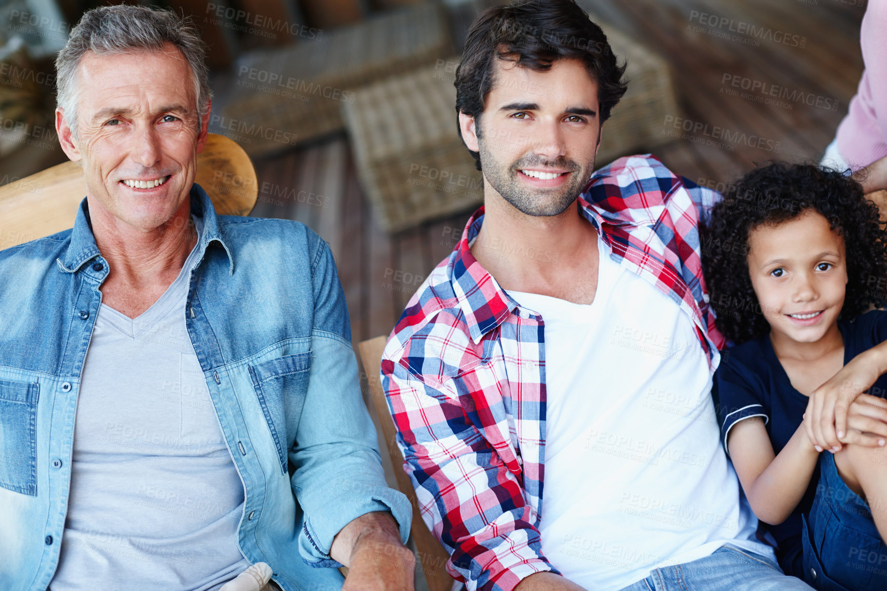 Buy stock photo Three generations of males from one family sitting together at home