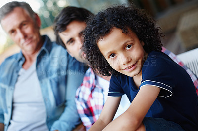 Buy stock photo Three generations of males from one family sitting together at home