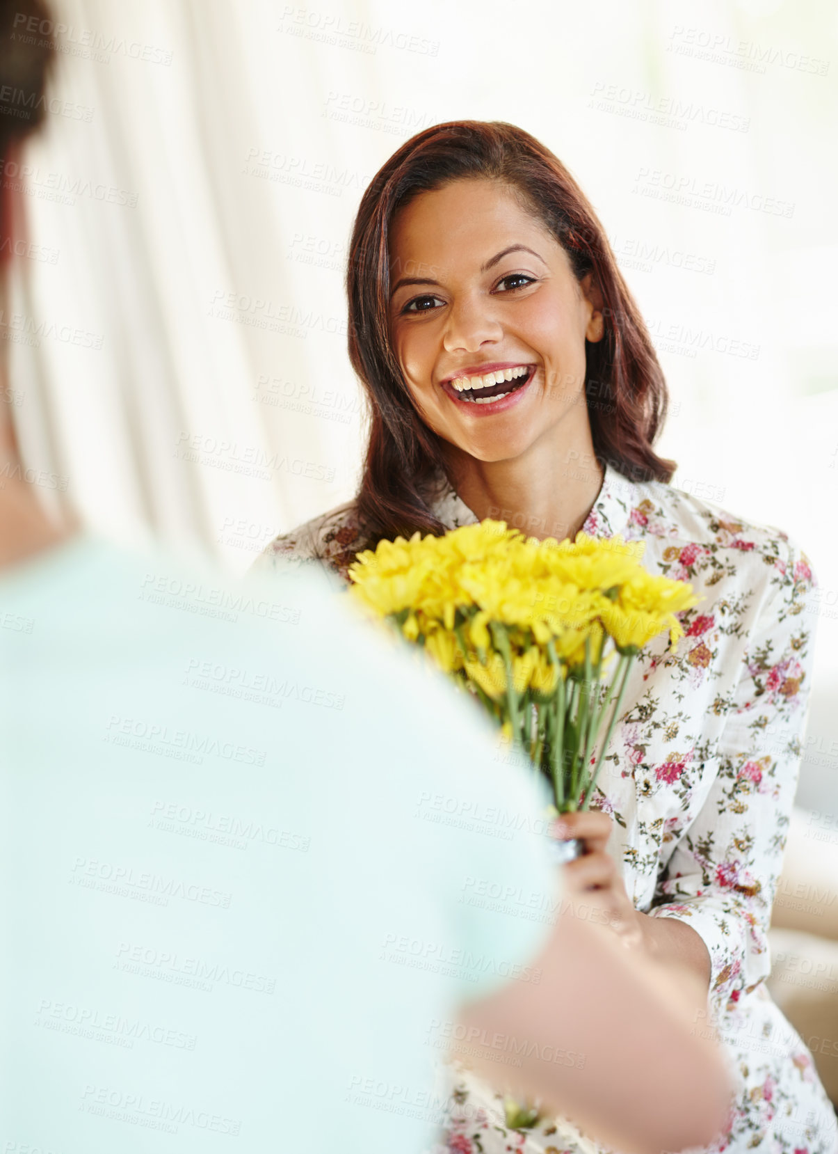 Buy stock photo Woman, flowers and receiving gift with happy or surprised for anniversary in living room with smile. Wow, valentines day and relationship with shocked for bouquet or present with romance in Spain.