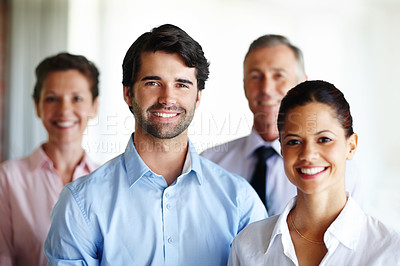 Buy stock photo A group of corporate co workers standing alongside each other