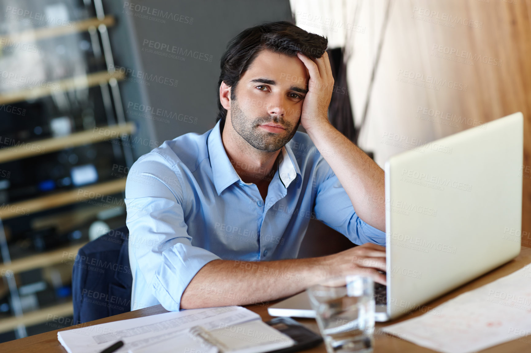 Buy stock photo Tired, laptop and portrait of business man at desk in office with pressure of project deadline. Bankruptcy, burnout or debt and accountant with depression working on computer for audit or tax