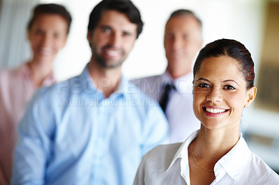 Buy stock photo A confident businesswoman standing infront of her colleagues