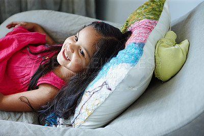 Buy stock photo Little girl lying on the couch in her home