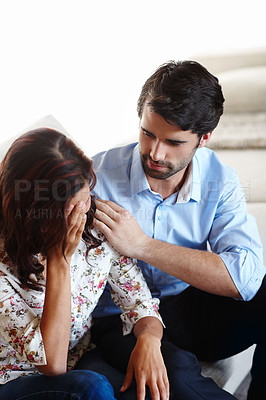Buy stock photo A young couple comforting each other through difficult times